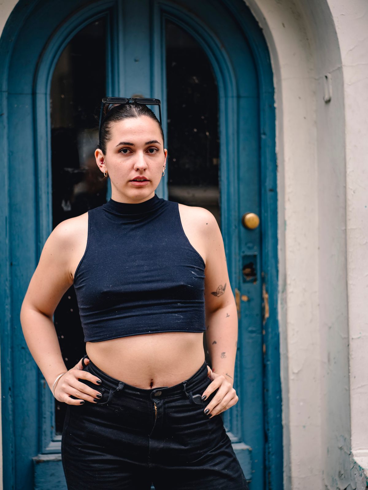 A navy sleeveless top worn with black trousers