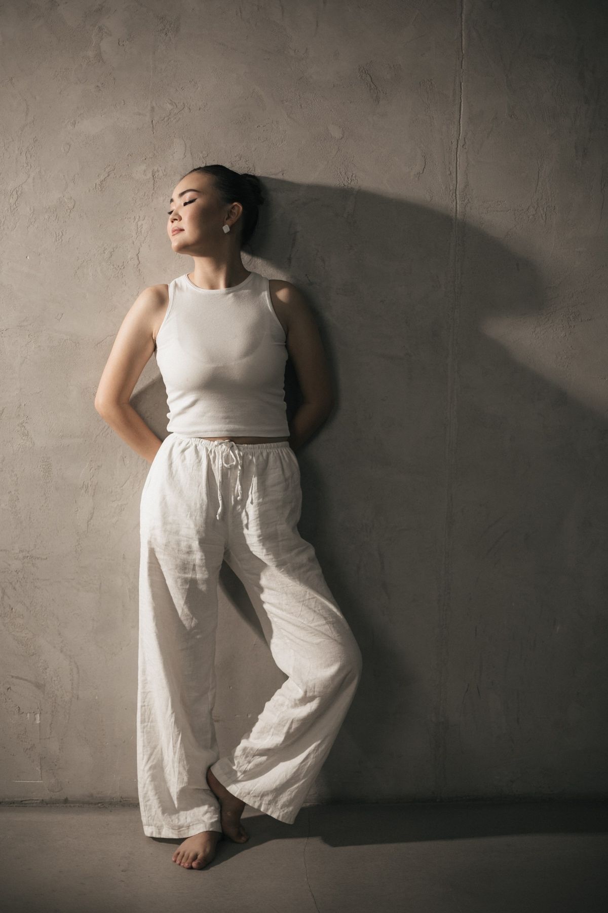 Pale linen trousers with a simple sleeveless top