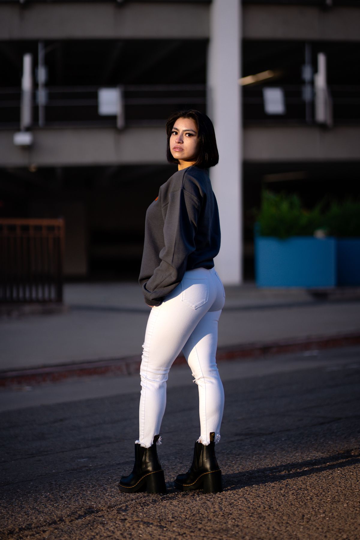 White jeans worn with a dark jumper and black boots