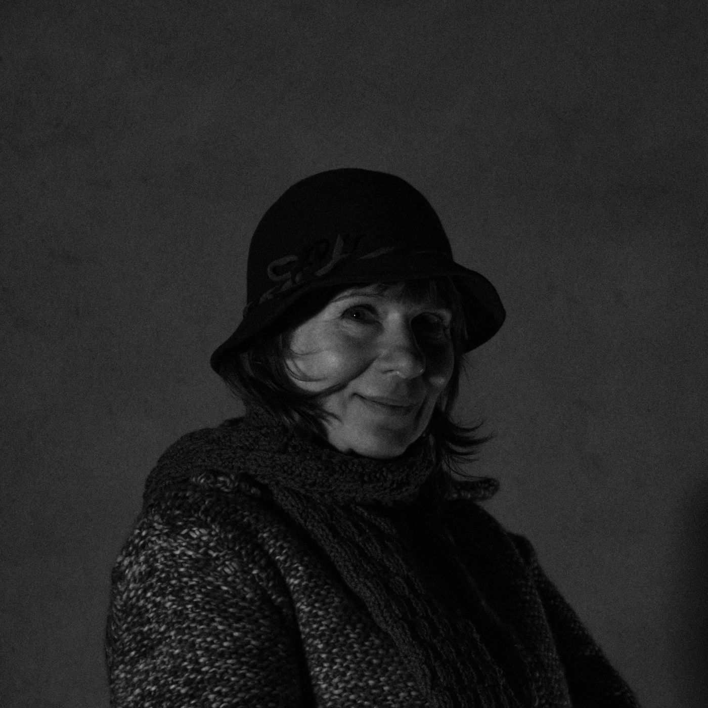 A textured winter scarf worn with a coat and hat