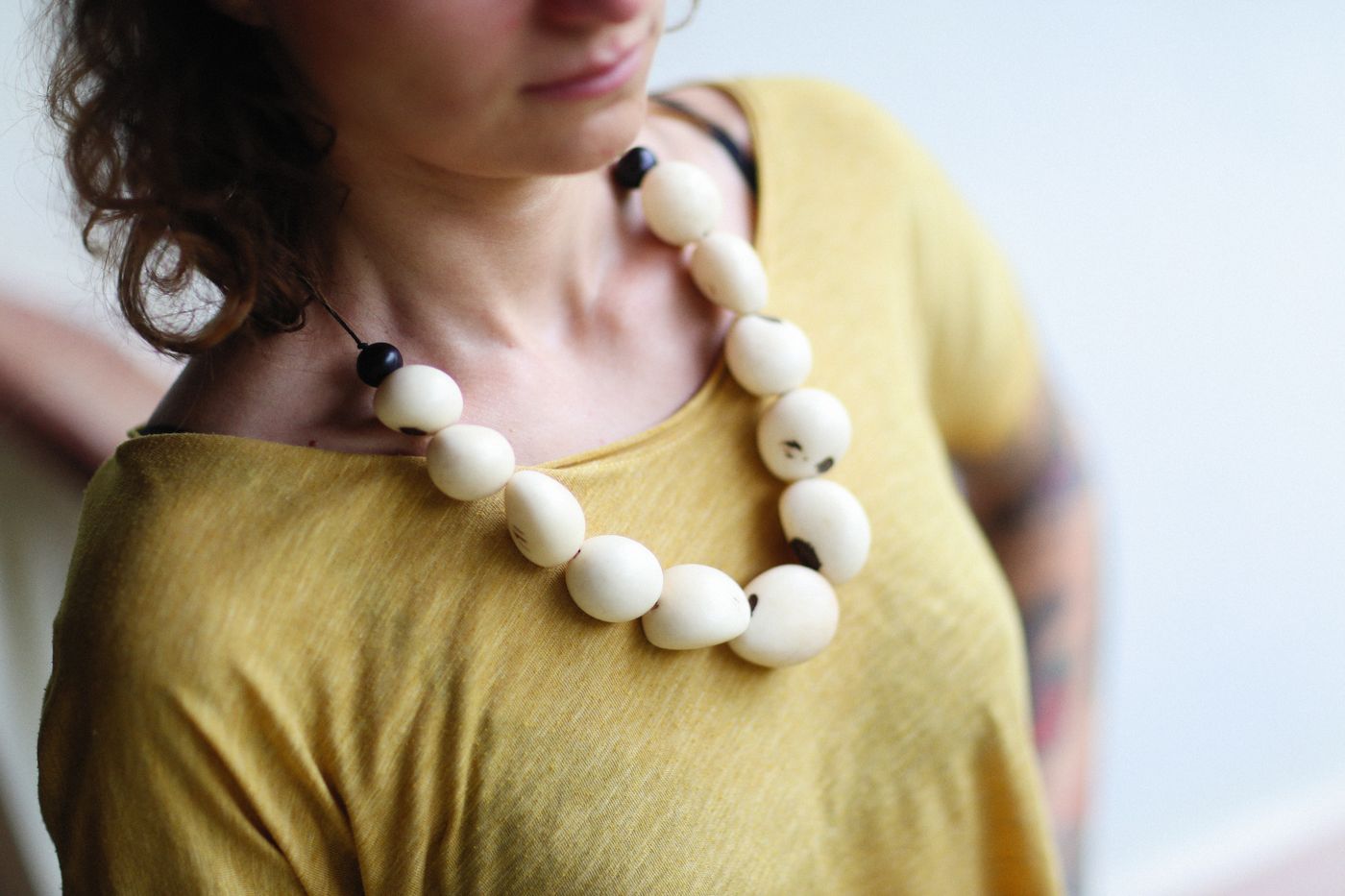 A chunky necklace sitting above a curved neckline