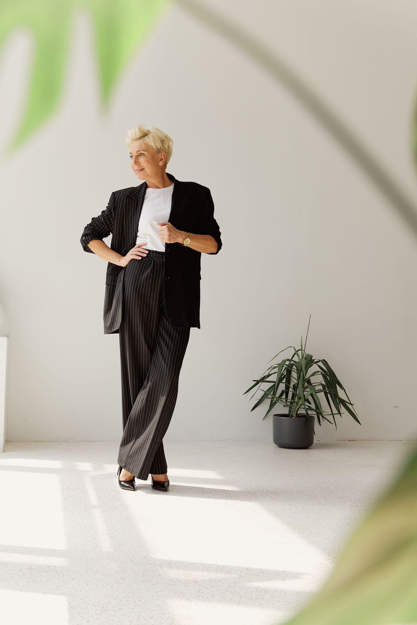 A dark trouser suit worn with a light top