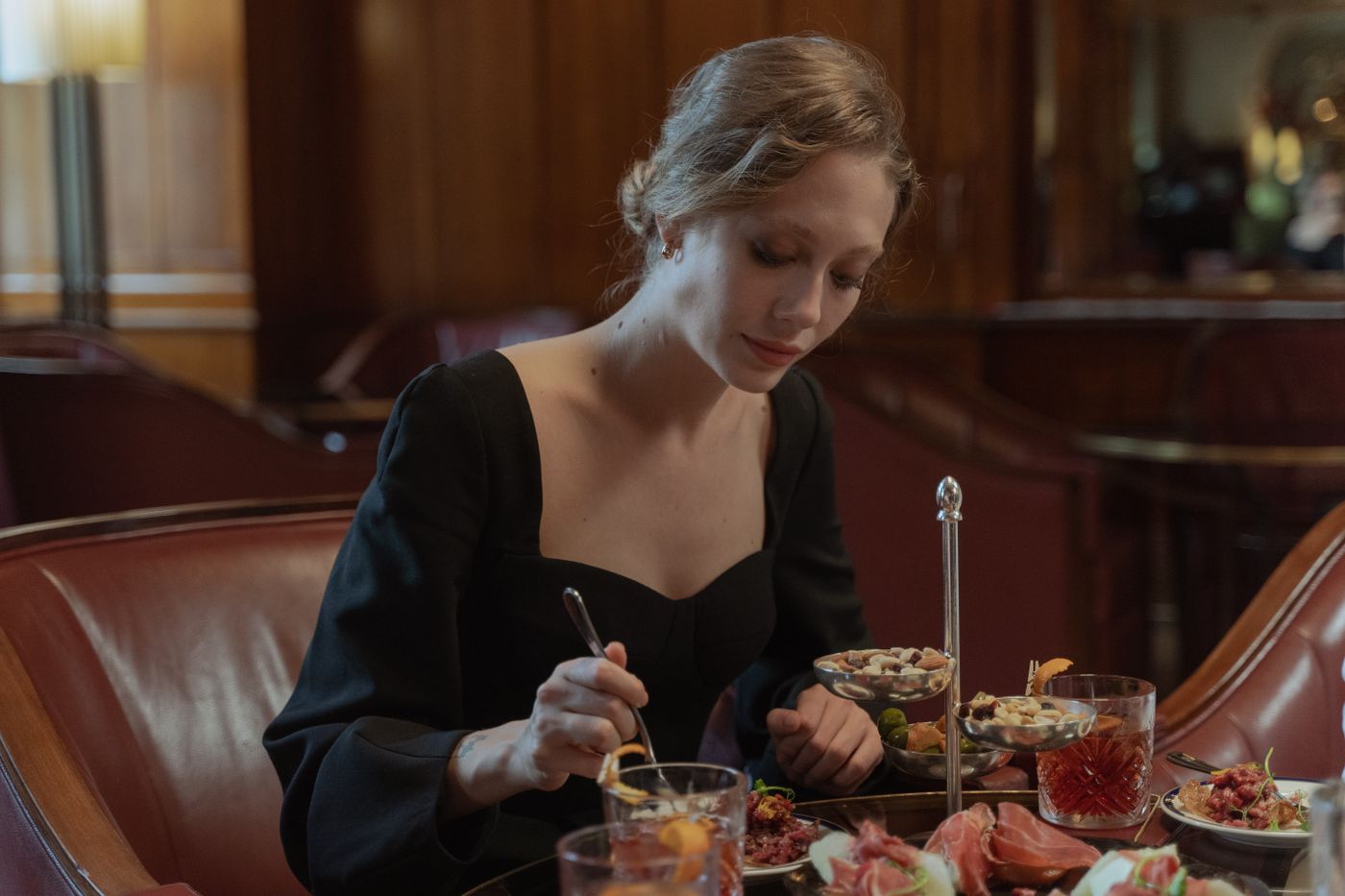 A black dress worn at a restaurant table