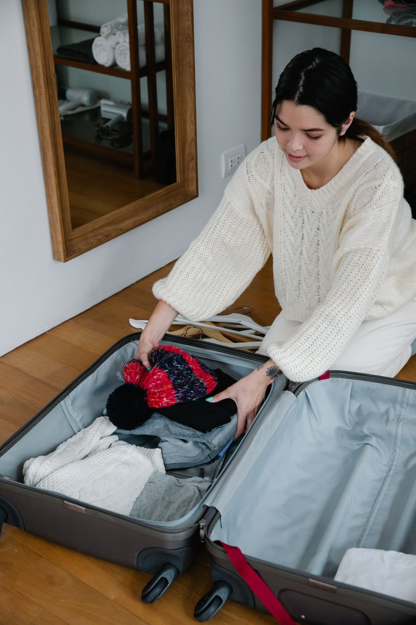 Clothes being arranged in a suitcase