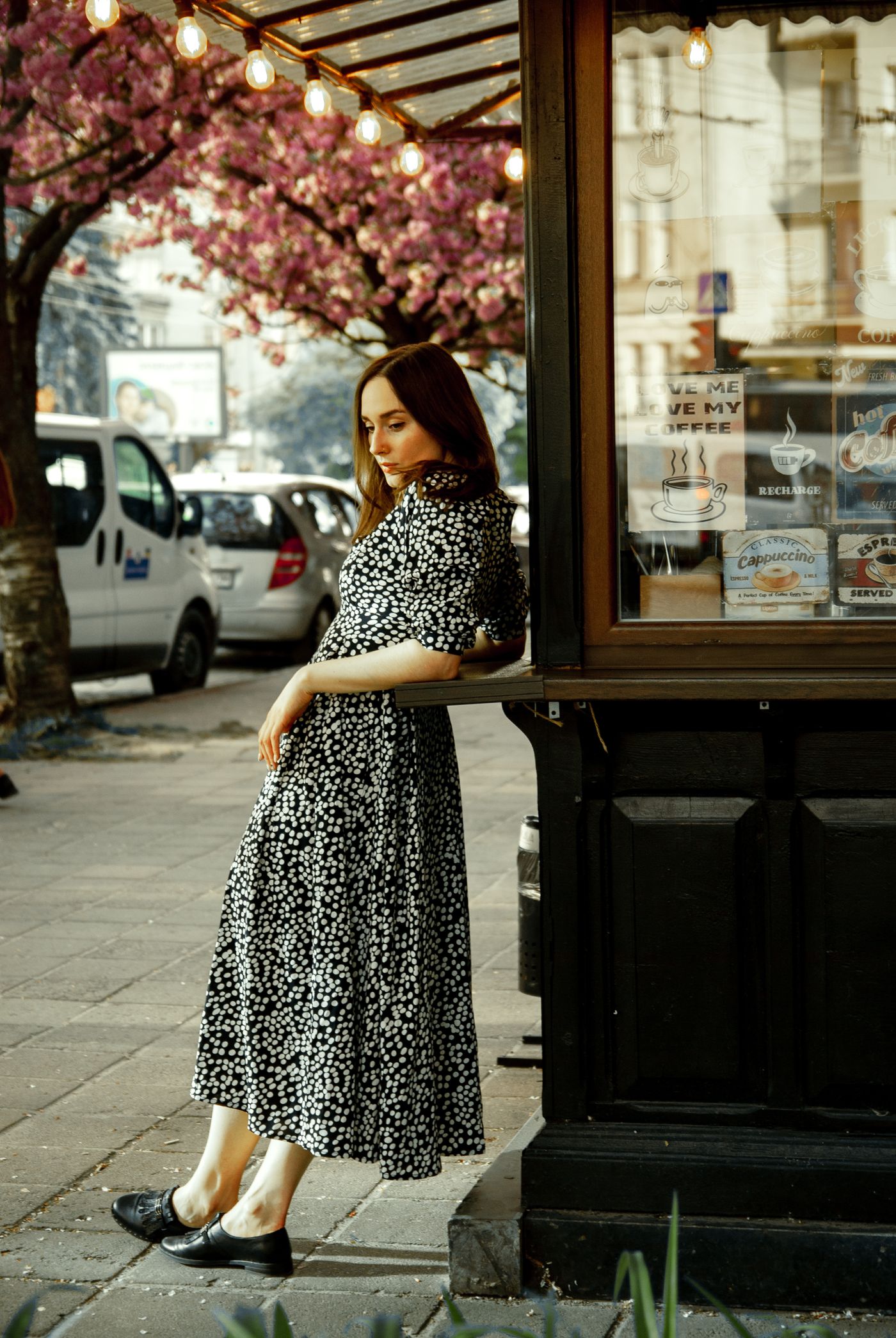 A patterned midi dress worn on a pavement