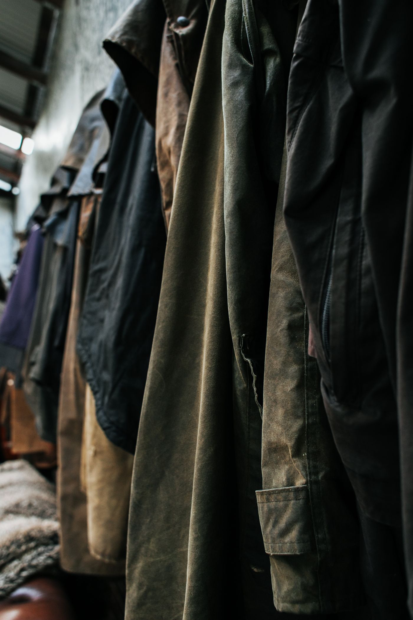 Second-hand outerwear hanging side by side