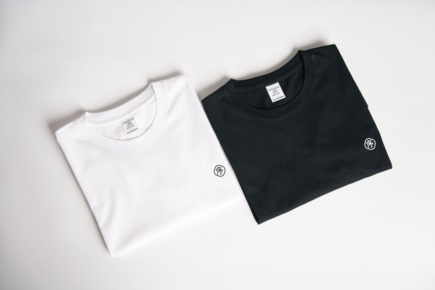 Black and white basic T-shirts folded side by side